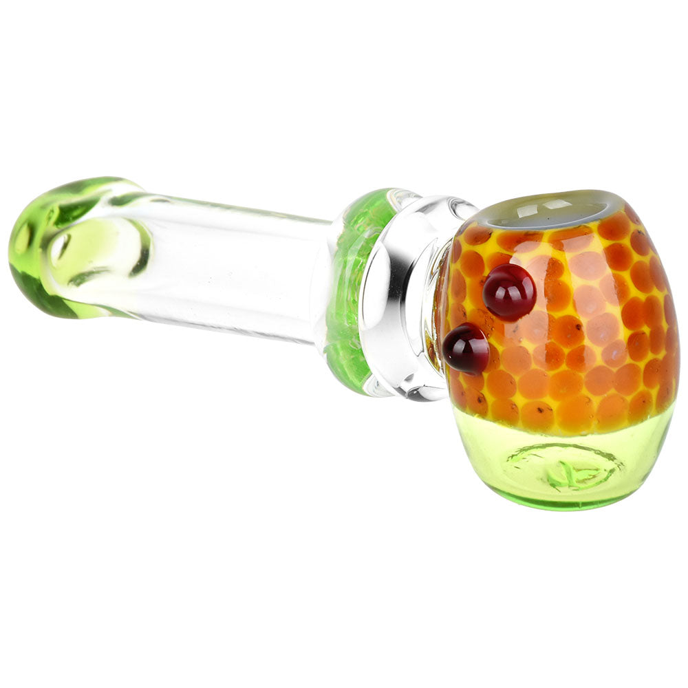 Glass smoking accessory with honeycomb design on a white background