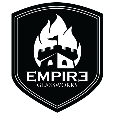 Logo of Empire Glassworks with a castle and flames design on a black shield.