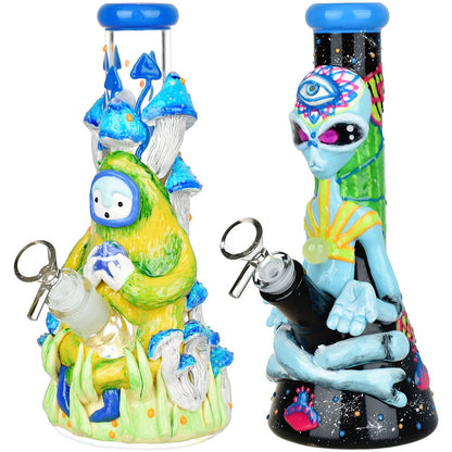 Two colorful alien-themed bongs with unique designs on a white background