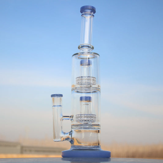 Glass water pipe with multiple chambers on a reflective surface